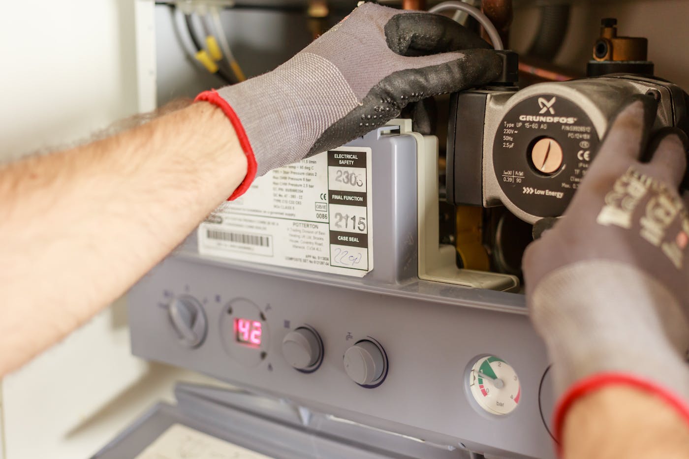 Licensed plumber servicing a home heating and water system in Durham Region