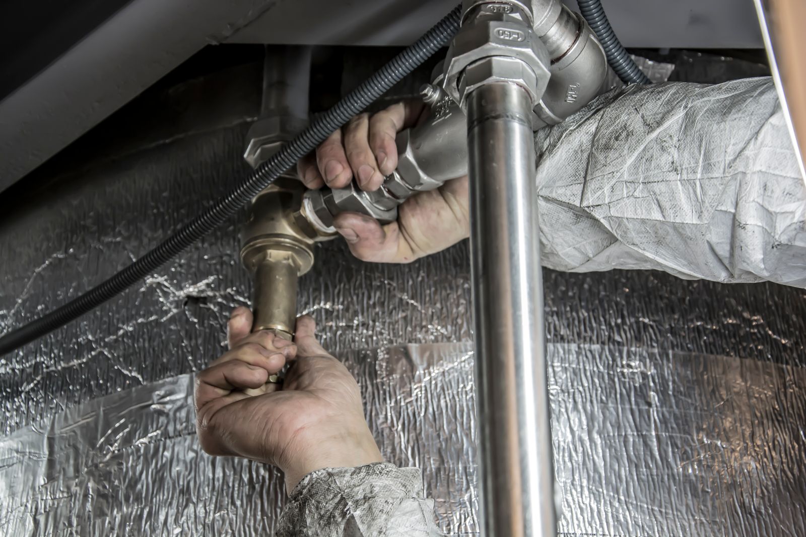 Licensed plumber repairing pipes in Ajax, Ontario